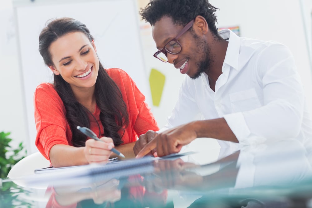 Smiling designers working together at their desk